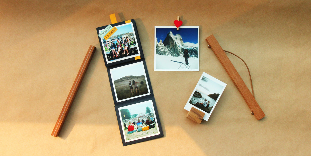 Accordion-fold photo card standing open on a party table