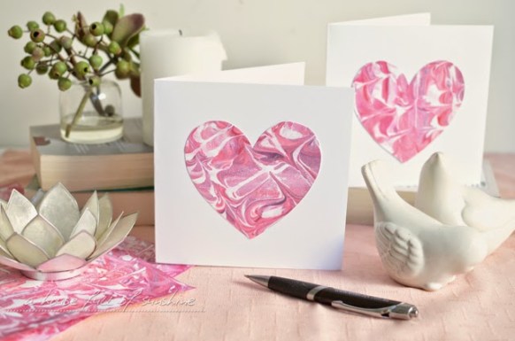 A handmade squash card opened out to show small square photo prints