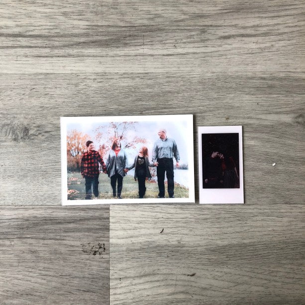 A lenticular GIF print held in the hand, showing the ribbed lens surface