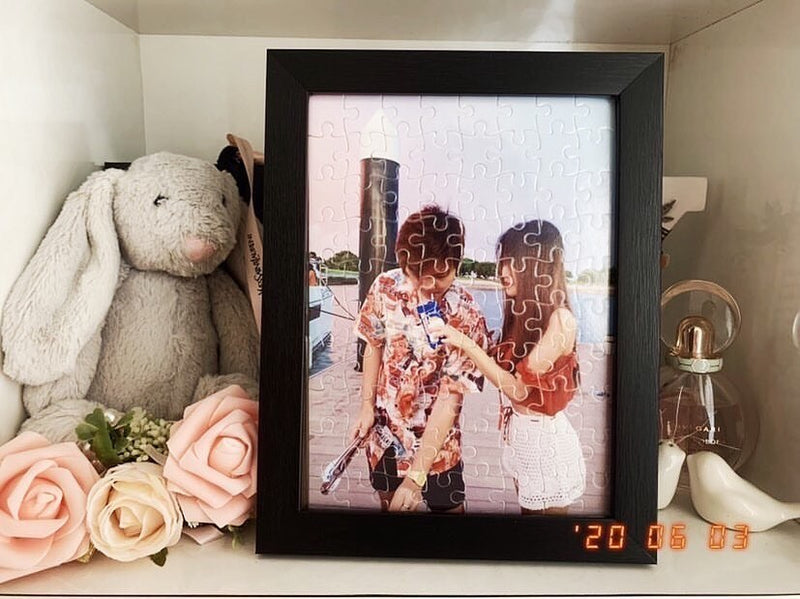 Framed photo jigsaw puzzle of a couple on a bedside shelf