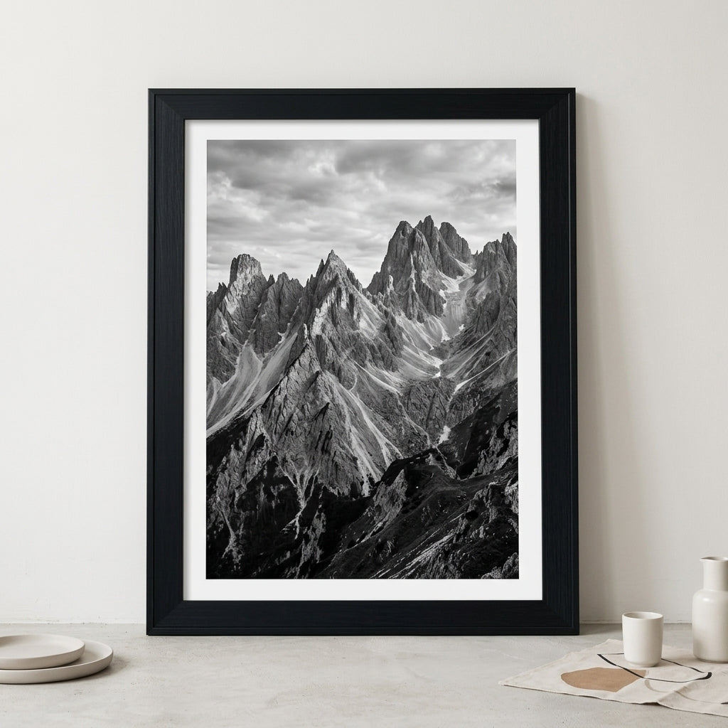 Large framed poster in a wide black wood frame leaning against a wall