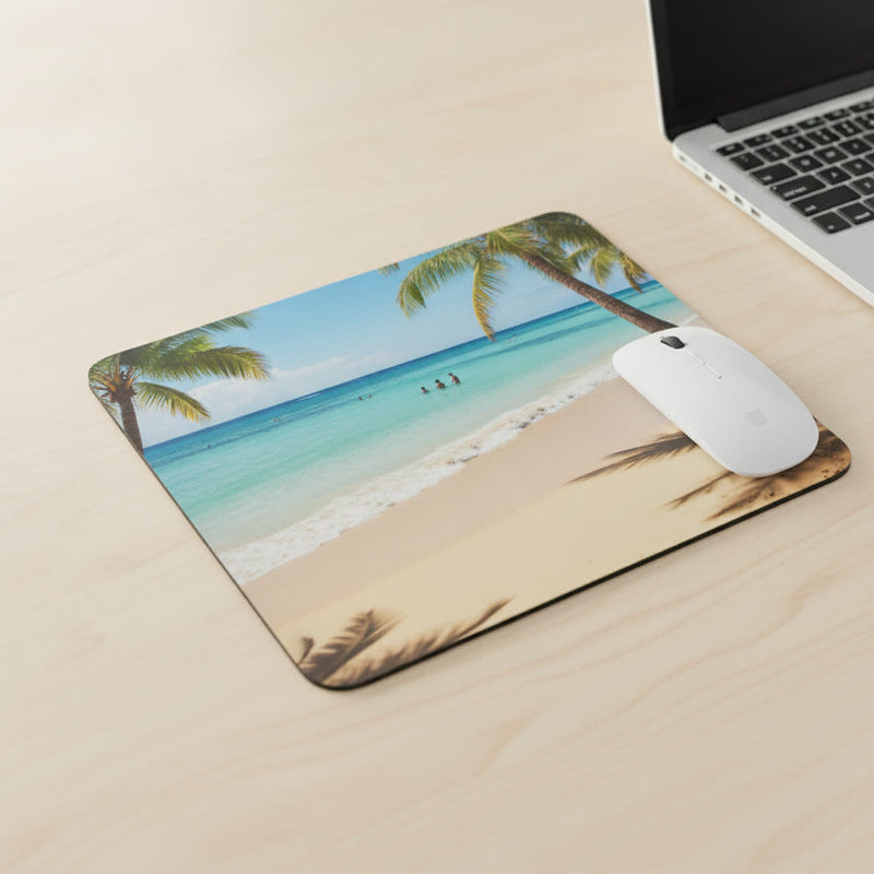 Photo mousepad printed edge to edge with a beach photo, on a desk with a laptop